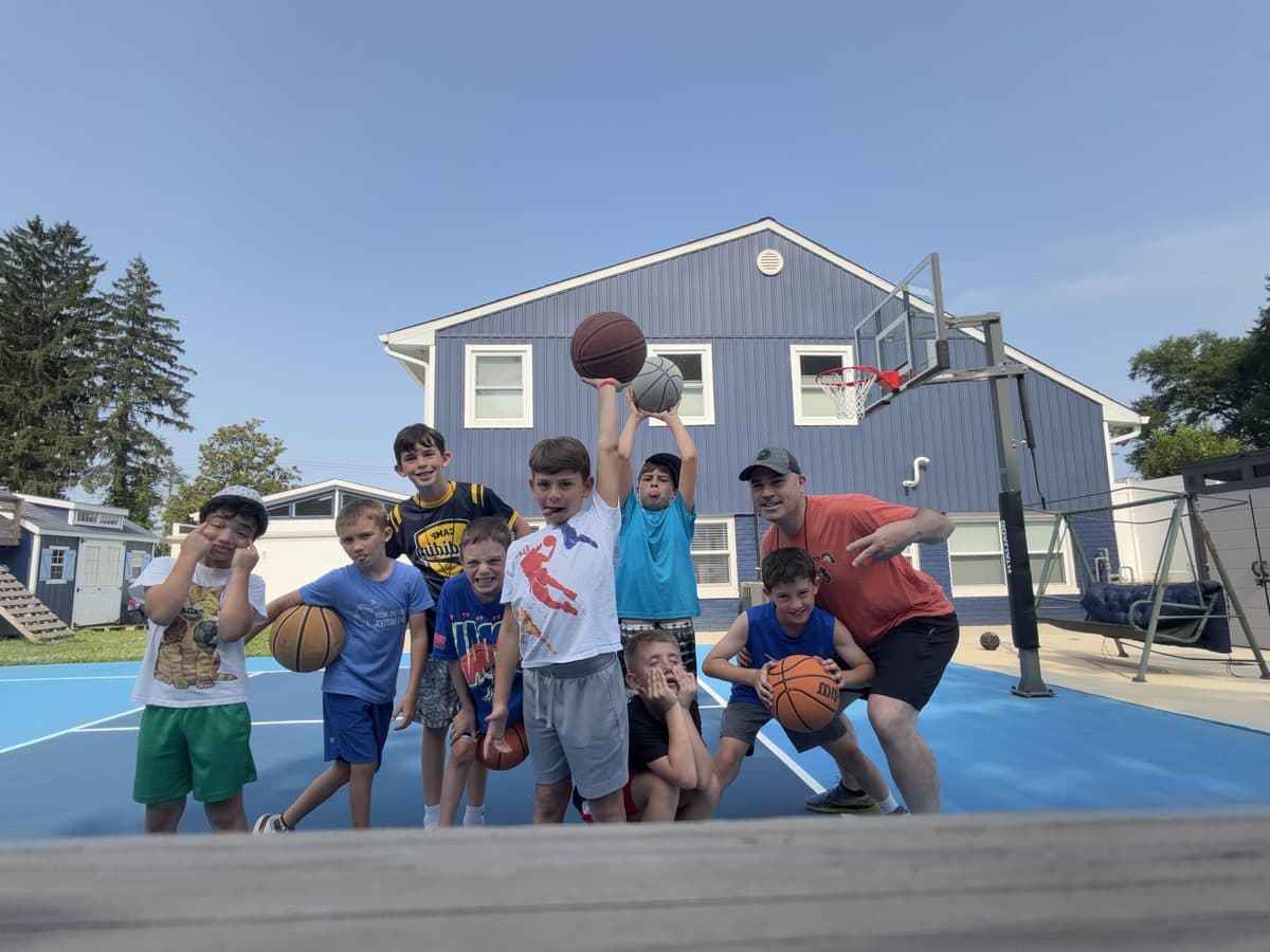 Athletes on the court with basketballs at a Harry's Hoops session
