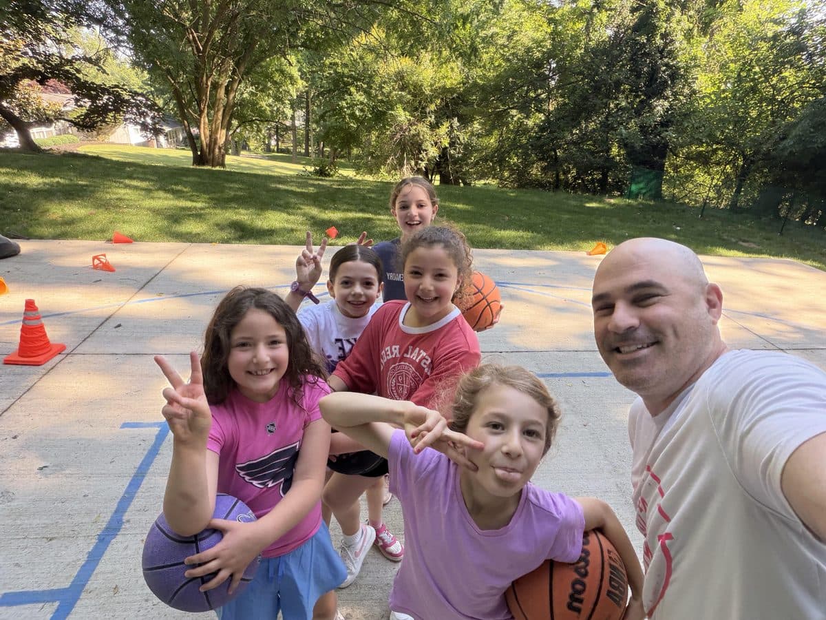 Coach Harry with athletes at a Harry's Hoops clinic